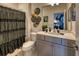 The bathroom showcases a vanity with modern fixtures and a coordinated shower curtain, plus Maleficent themed artwork at 6301 Sand Skipper Rd, Orlando, FL 32821