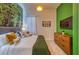 Cozy bedroom featuring a mural, king bed with decorative pillows, complemented by stylish lighting at 6301 Sand Skipper Rd, Orlando, FL 32821