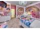 This bedroom showcases a princess theme, including mural walls, white furniture, and chandelier lighting at 6301 Sand Skipper Rd, Orlando, FL 32821