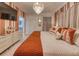Serene bedroom with orange accents, a crystal chandelier, and a mounted television at 6301 Sand Skipper Rd, Orlando, FL 32821