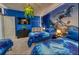 This themed bedroom features two twin beds, a TV, custom murals, and unique lighting fixtures at 6301 Sand Skipper Rd, Orlando, FL 32821