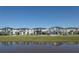Modern two-story homes with neatly maintained lawns are reflected in a scenic waterfront view at 6301 Sand Skipper Rd, Orlando, FL 32821