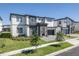 Beautiful two-story home showcasing modern design, stone accents, a well-manicured lawn, and a gray paved driveway at 6301 Sand Skipper Rd, Orlando, FL 32821