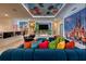 Bright and fun game room with custom cartoon decor and ample seating for the whole Gathering at 6301 Sand Skipper Rd, Orlando, FL 32821