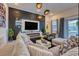 Contemporary living room featuring a fireplace, sleek decor, plush seating, and natural light at 6301 Sand Skipper Rd, Orlando, FL 32821