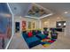 Spacious game room with bright accents, Disney theme, stylish furnishings, and multiple gaming chairs at 6301 Sand Skipper Rd, Orlando, FL 32821