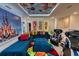 Spacious living room with Disney theme, featuring stylish furnishings, bright accents, and gaming chairs at 6301 Sand Skipper Rd, Orlando, FL 32821