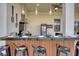 The outdoor kitchen offers bar seating, stainless steel appliances, and stylish pendant lighting at 6301 Sand Skipper Rd, Orlando, FL 32821