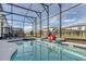 Sparkling screened-in pool and jacuzzi with a Mickey Mouse float, perfect for Gathering fun at 6301 Sand Skipper Rd, Orlando, FL 32821