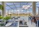 Covered outdoor dining area with a long table, bar seating, and views of the pool and backyard at 6301 Sand Skipper Rd, Orlando, FL 32821