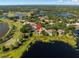 Aerial view of a lakeside home with a pool and lush landscaping in a desirable community at 709 Cricklewood Ter, Lake Mary, FL 32746