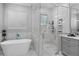 Bright bathroom showcasing a tub, glass shower, marble accents, and modern fixtures at 709 Cricklewood Ter, Lake Mary, FL 32746