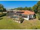 Backyard with a screened pool, solar panels, and meticulously maintained lawn at 709 Cricklewood Ter, Lake Mary, FL 32746