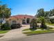 Beautiful single-story home featuring a terra cotta roof, manicured landscaping, and a paver driveway at 709 Cricklewood Ter, Lake Mary, FL 32746