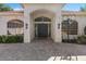 Close-up of the home's entrance and paver pathway, featuring an arched doorway and immaculate landscaping at 709 Cricklewood Ter, Lake Mary, FL 32746