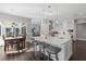 Bright kitchen with a center island, pendant lights, hardwood floors, and an adjacent dining area at 709 Cricklewood Ter, Lake Mary, FL 32746
