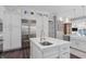 Elegant kitchen with white cabinets, stainless steel appliances, island sink, and a view of the water at 709 Cricklewood Ter, Lake Mary, FL 32746