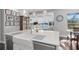Bright kitchen with a large white island and sink overlooking a lake view at 709 Cricklewood Ter, Lake Mary, FL 32746