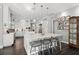 Spacious kitchen featuring a center island with seating, custom cabinets, and hardwood floors at 709 Cricklewood Ter, Lake Mary, FL 32746