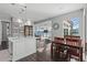 Open kitchen and dining area with views of the lake and backyard through large windows at 709 Cricklewood Ter, Lake Mary, FL 32746