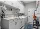 Well-equipped laundry room with marble counters, ample cabinetry, modern washer/dryer and designer organization at 709 Cricklewood Ter, Lake Mary, FL 32746