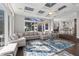 Bright, open-concept living room with coffered ceilings and views into the kitchen and outdoor spaces at 709 Cricklewood Ter, Lake Mary, FL 32746