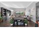 Spacious living room featuring dark hardwood floors, stylish decor, and sliding glass doors to the backyard at 709 Cricklewood Ter, Lake Mary, FL 32746