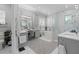 Bright main bathroom featuring dual vanities, a soaking tub, a walk-in shower, and plenty of counter space at 709 Cricklewood Ter, Lake Mary, FL 32746