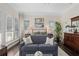 Bright main bedroom featuring hardwood floors, shuttered windows, a sitting area, and a serene atmosphere at 709 Cricklewood Ter, Lake Mary, FL 32746