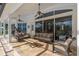 Covered patio with tile flooring, fan, ample seating and steps down to backyard at 709 Cricklewood Ter, Lake Mary, FL 32746