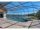 Relaxing pool and spa in a screened enclosure, offering serenity and lake views at 709 Cricklewood Ter, Lake Mary, FL 32746