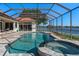 The caged pool area features a pool, hot tub, and deck with lake views at 709 Cricklewood Ter, Lake Mary, FL 32746