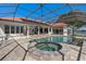Stunning pool with spa in screened enclosure, complemented by tiled deck and lake views at 709 Cricklewood Ter, Lake Mary, FL 32746