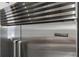 Close-up of a stainless steel Sub-Zero refrigerator integrated into the kitchen cabinetry at 709 Cricklewood Ter, Lake Mary, FL 32746