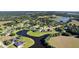 Community aerial view showing manicured lawns and lake access for most homes at 7351 Spring Mountain Ln, Yalaha, FL 34797