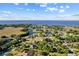Enjoy an aerial view of this lakefront neighborhood, with its lush landscaping and tranquil atmosphere at 7351 Spring Mountain Ln, Yalaha, FL 34797