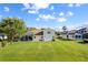 Expansive backyard featuring a screened enclosure, lush lawn, and well-maintained landscaping at 7351 Spring Mountain Ln, Yalaha, FL 34797