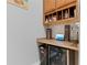 Home bar area with custom cabinetry, wine cooler, and countertop space for entertaining at 7351 Spring Mountain Ln, Yalaha, FL 34797