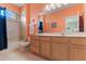 Bathroom featuring an arched window over tub-shower combo, tile flooring, and vanity with double sinks at 7351 Spring Mountain Ln, Yalaha, FL 34797