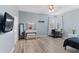 Bedroom featuring wood-look floors, vanity area, and natural light from multiple windows at 7351 Spring Mountain Ln, Yalaha, FL 34797