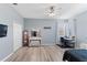 Bedroom featuring wood-look floors, vanity area, and natural light from multiple windows at 7351 Spring Mountain Ln, Yalaha, FL 34797