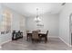 Bright dining room featuring a stylish chandelier and large windows at 7351 Spring Mountain Ln, Yalaha, FL 34797