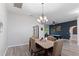 Inviting dining area with a chandelier, table seating four, and an open view to the game room at 7351 Spring Mountain Ln, Yalaha, FL 34797
