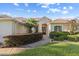 Inviting front entrance with red double doors and manicured landscaping at 7351 Spring Mountain Ln, Yalaha, FL 34797