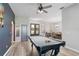 Spacious game room featuring a pool table and view of the dining room at 7351 Spring Mountain Ln, Yalaha, FL 34797