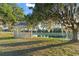 Idyllic lakeside gazebo with a beautiful view, perfect for relaxation and enjoying nature at 7351 Spring Mountain Ln, Yalaha, FL 34797
