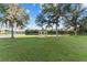 Scenic view of a gazebo surrounded by lush greenery and serene water at 7351 Spring Mountain Ln, Yalaha, FL 34797