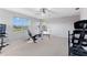 Home gym showcasing exercise equipment and a scenic view through large windows at 7351 Spring Mountain Ln, Yalaha, FL 34797