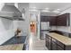 Modern kitchen with granite countertops, stainless steel appliances, and ample cabinet space at 7351 Spring Mountain Ln, Yalaha, FL 34797