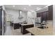 Spacious kitchen with granite countertops, stainless steel appliances, and an eat-in dining area at 7351 Spring Mountain Ln, Yalaha, FL 34797